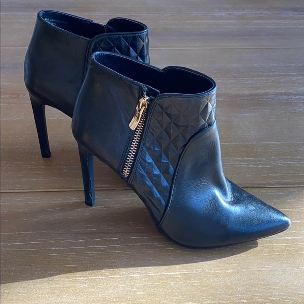Black ankle boots with gold zipper hardware